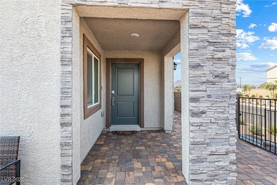 Property entrance with stucco siding and stone siding