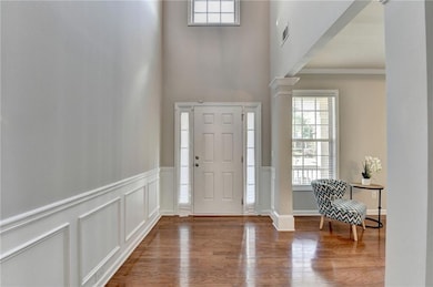 Entrance foyer featuring decorative columns, healt