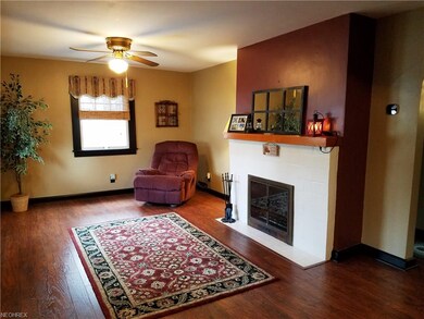 The bright living room has oak floors and a wood-b