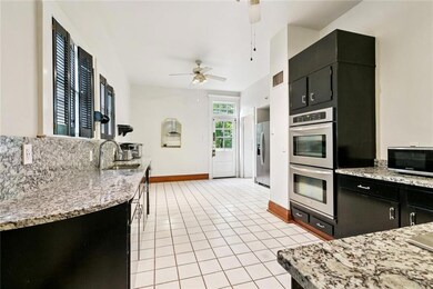 Kitchen with rear door leading to deck.