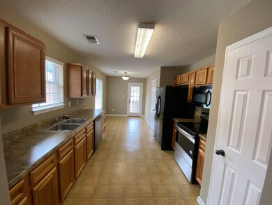 Kitchen featuring a healthy amount of sunlight, ap