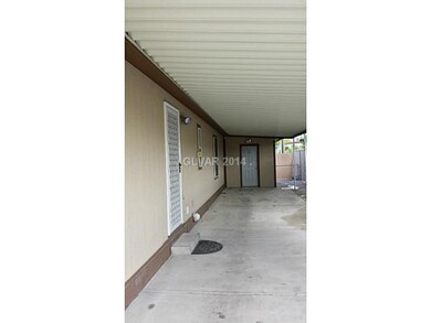 Property Photo. Carport (Door at end is Shed)