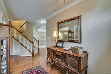 Inviting entrance with wood floors that open to fo