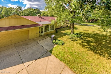 Backyard view of the home. 2-car attached garage and access to the sunroom.