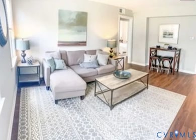Living room featuring baseboards and wood finished floors