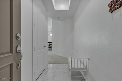 Hall with marble finish floor and baseboards