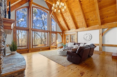 Living area featuring beamed ceiling, high vaulted