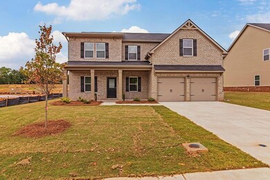 View of front of home featuring covered porch, a g