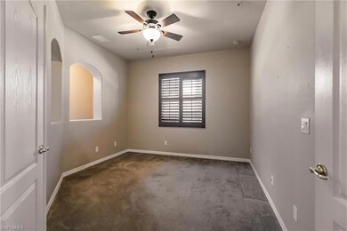 Carpeted spare room with ceiling fan