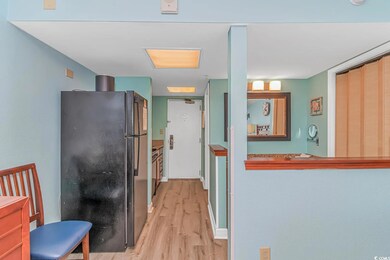 Kitchen with light wood-type flooring and black re