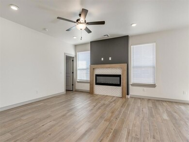 Unfurnished living room with a tile fireplace, cei