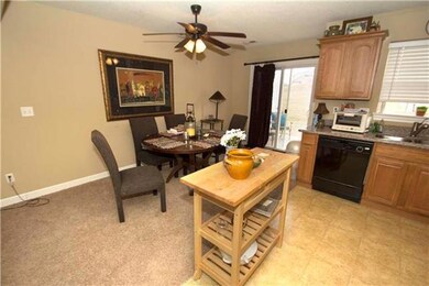 From the dining area with lighted ceiling fan, a s