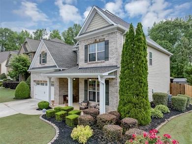 View of front facade featuring driveway, brick sid