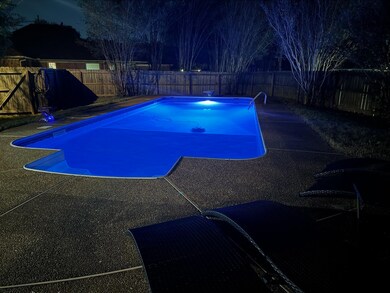 Pool at twilight featuring a patio