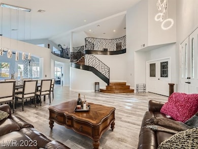 Living area featuring high vaulted ceiling, wood f