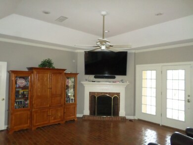 Living Room With Tray Ceilings, Brick Floors