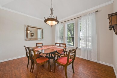 Dining room featuring crown molding and Pergo Premium floors
