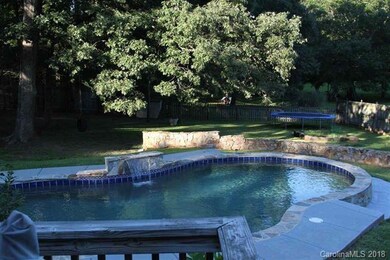 Beautiful in-ground pool with waterfall.