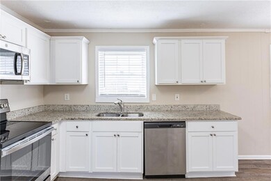 Kitchen with white cabinetry, stainless steel appl