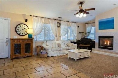 Living room features travertine floor and gas log 