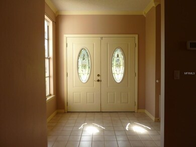 Double front doors and foyer with garage door entr