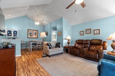 Living area with vaulted ceiling, laminate finishe