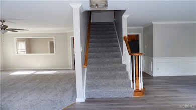 Stairs with ornamental molding, a wainscoted wall,