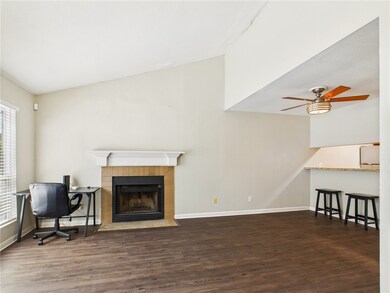 Living area with wood finished floors, a tile fire
