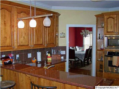 THE KITCHEN HAS PLENTY OF CABINETRY, GRANITE COUNTERTOPS AND BACKSPLASH, GAS STOVE, CONVENTION OVEN, MICROWAVE AND LARGE PANTRY.