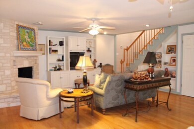 LivingRm w/fireplace: Custom cabinets and bookshel