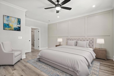 Bedroom featuring ceiling fan, crown molding, and 