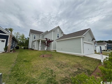 View of front of house with a front lawn, driveway, and a garage