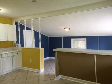 Kitchen overlooks enclosed garage, new windows thr