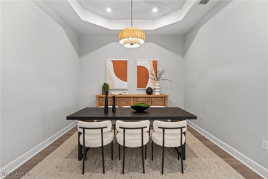 Dining space with dark wood-type flooring, a notab
