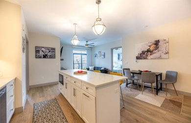 Kitchen featuring black microwave, light wood-styl