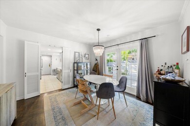 Dining space with a chandelier, dark wood-style f