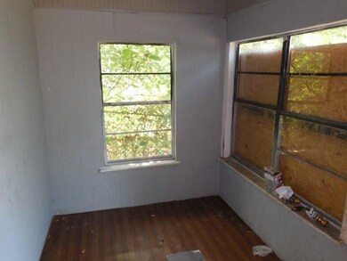 Empty room with hardwood / wood-style flooring