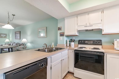 Kitchen featuring white electric range oven, black