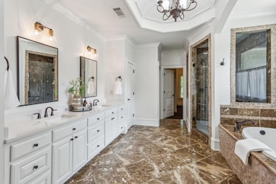 Spa-Style Primary Ensuite With Dual Vanities, Marble Tile, Soaking Tub, & Steam Shower