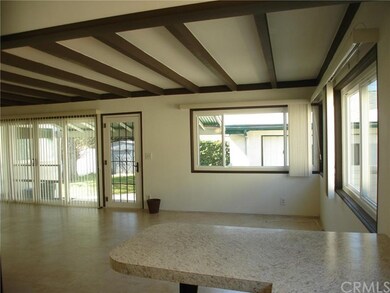 Large family room highlighted with real wood beams