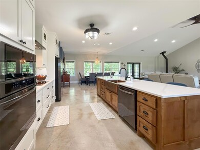 Kitchen with stainless steel dishwasher, brown ca