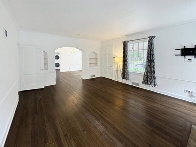 Unfurnished living room with ornamental molding an