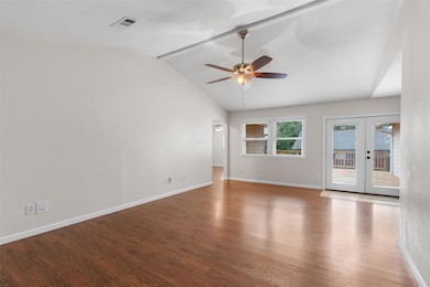 Unfurnished room featuring french doors, wood fin