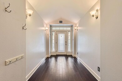 Foyer entrance with baseboards, visible vents, lo