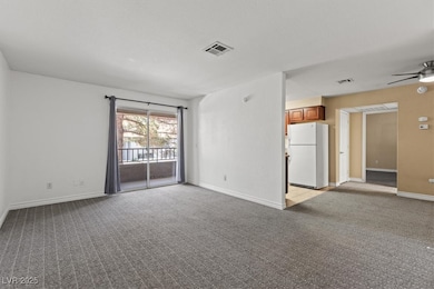Unfurnished room with light carpet, baseboards, an
