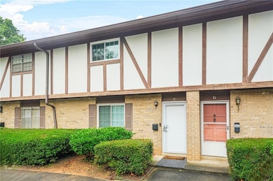 Doorway to property with brick siding and stucco siding