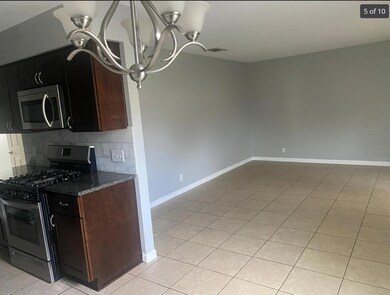 Kitchen with stainless steel appliances, light ti