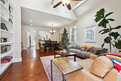 Living area with arched walkways, ceiling fan, co