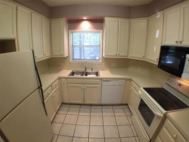 Kitchen with white cabinetry, light tile patterne