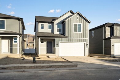 View of front of property featuring board and batten siding, concrete driveway, a garage, and a shingled roof